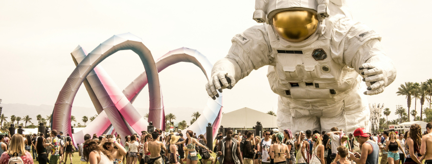 Coachella visitors next to a giant astronaut sculpture