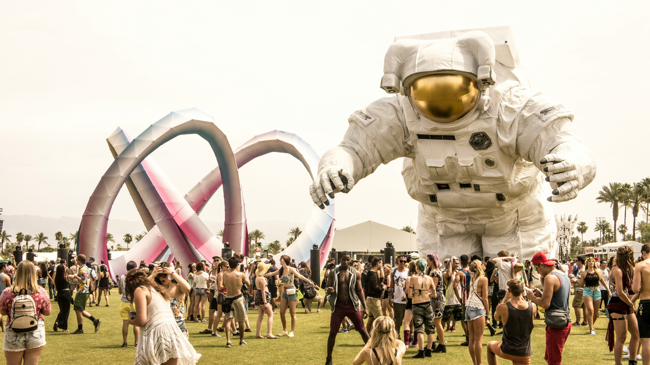 Coachella visitors next to a giant astronaut sculpture