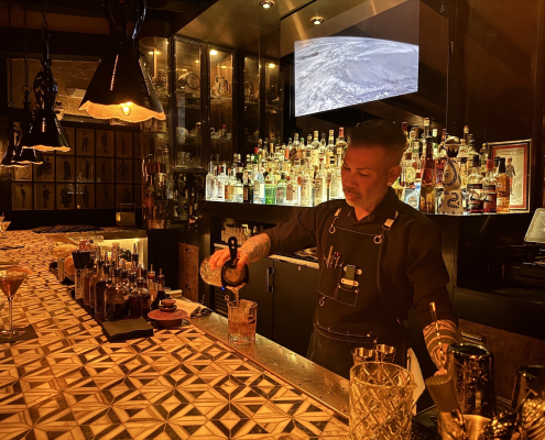 A bartender at Seymour's pours a drink behind the bar