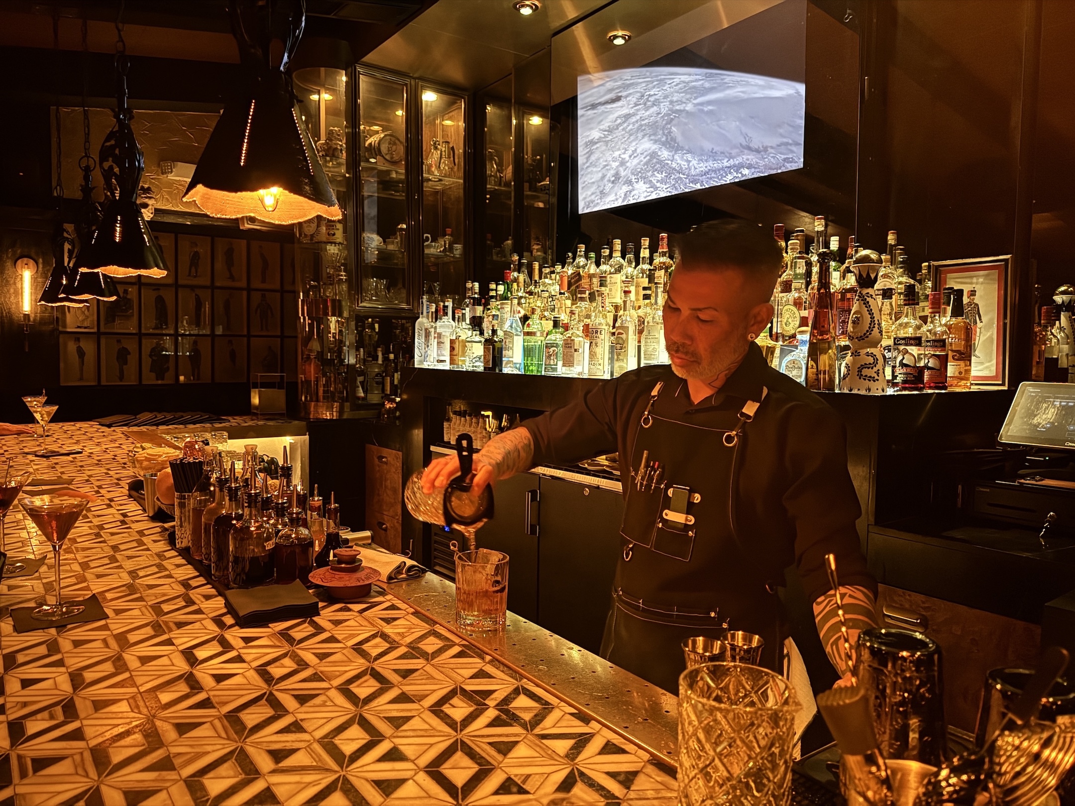 A bartender at Seymour's pours a drink behind the bar