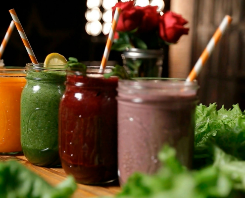 Colorful fruit smoothies in glass mason jars