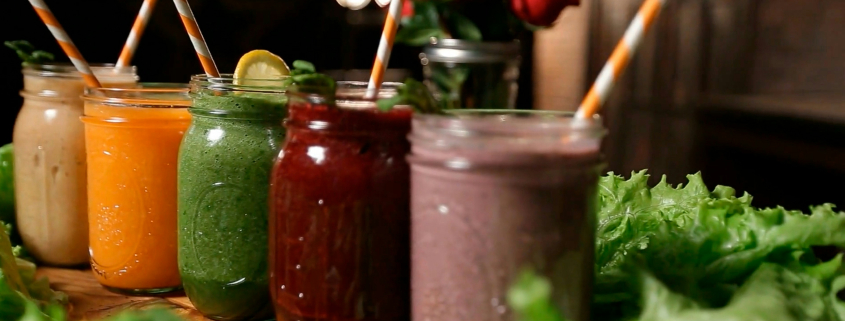 Colorful fruit smoothies in glass mason jars