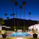 Night falls on the Hotel El Cid in Palm Springs, but the lights are still on in the pool area