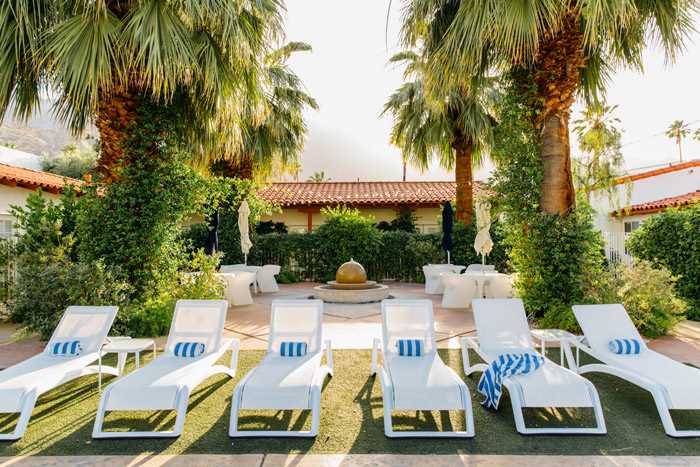 Lounge chairs at Alcazar Palm Springs to enjoy the California sun