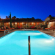 The pool at Los Arboles Hotel in Palm Springs is illuminated at night for night swimming